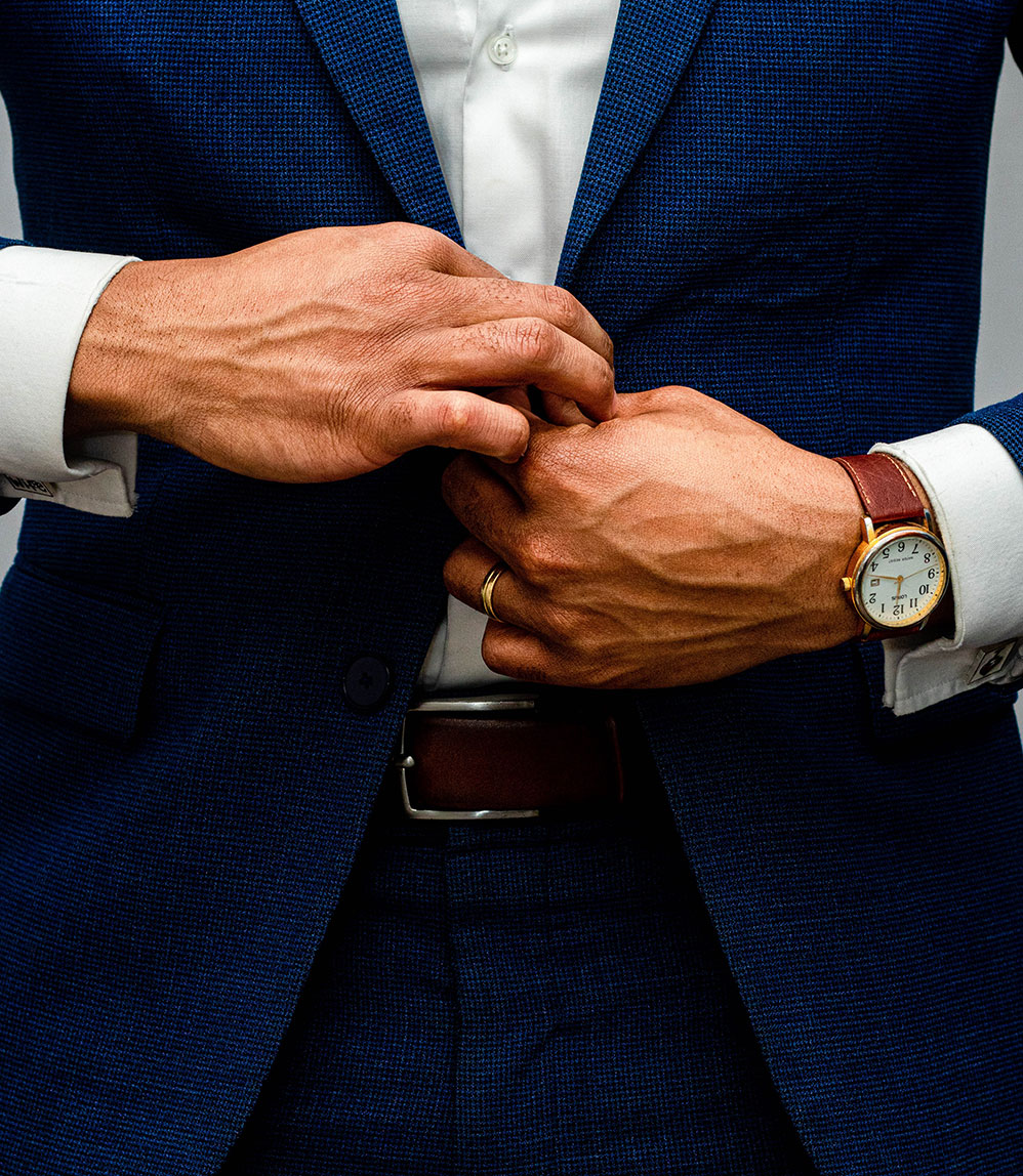 Man buttoning his suit jacket